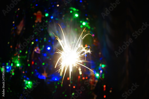 Sparkling sparklers at night. Bright Christmas background. A festive event.
