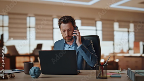 Wallpaper Mural Worried entrepreneur talking mobile phone in office. Angry man worker complain Torontodigital.ca