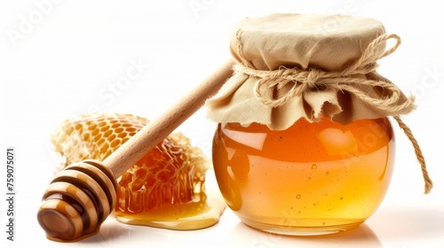 a jar of natural honey next to a wooden honey dipper.