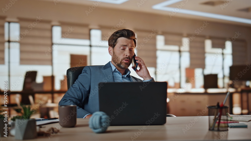 Entrepreneur man talking smartphone working at cabinet. Businessman gesturing Entrepreneur man talking smartphone working at cabinet. Businessman gesturing