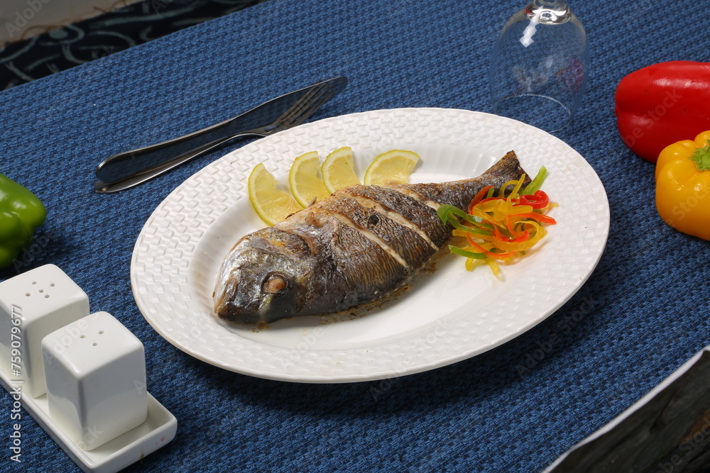 fried fish with fresh herbs and lemon restaurant blue table
fried fish with fresh herbs and lemon restaurant blue table
