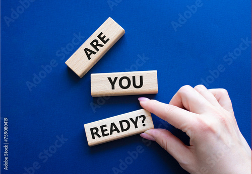 Are you ready symbol. Concept word Are you ready on wooden blocks. Businessman hand. Beautiful deep blue background. Business and Are you ready concept. Copy space