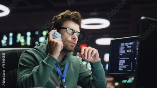 Thinking system administrator working computer in data center closeup. IT man