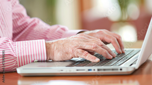 A person's hands typing on a laptop.