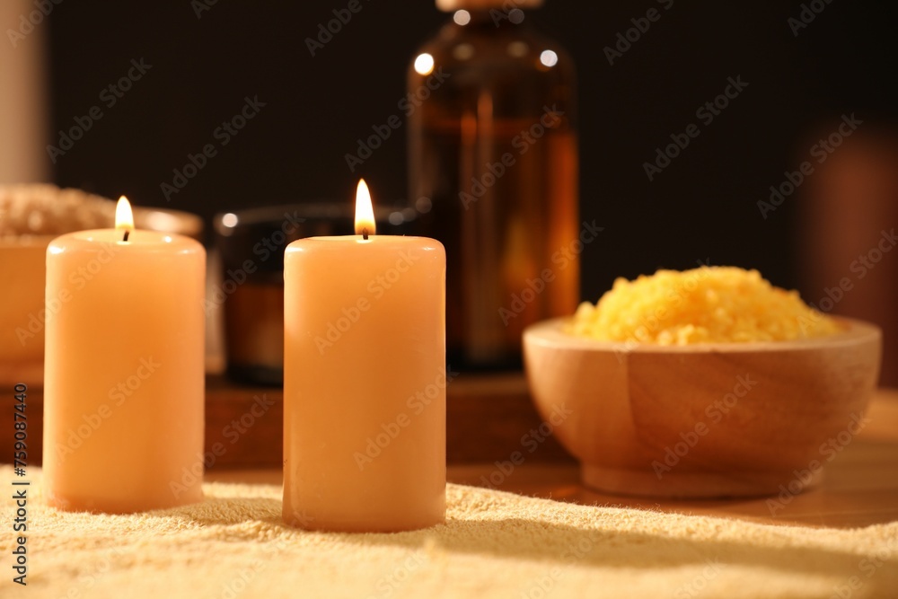 Spa composition with burning candles and personal care products on soft light surface, closeup Spa composition with burning candles and personal care products on soft light surface, closeup