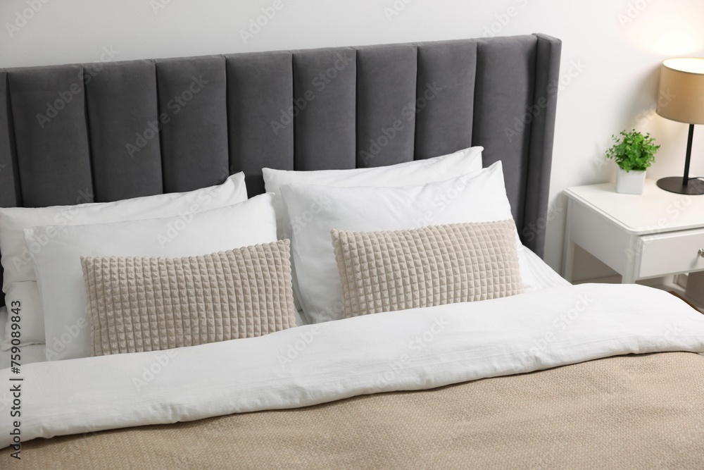 Obraz premium Soft pillows and duvet on bed at home
