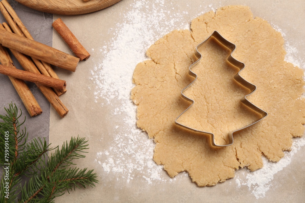 Making Christmas cookies. Flat lay composition with ingredients and raw dough on grey table Making Christmas cookies. Flat lay composition with ingredients and raw dough on grey table