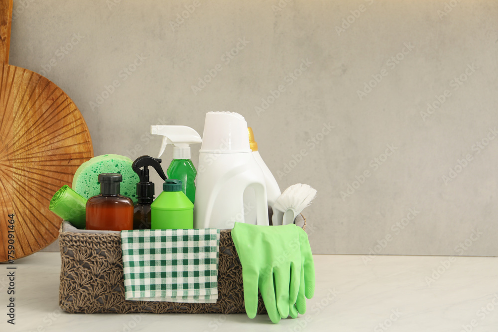 Different cleaning supplies in basket on countertop. Space for text Different cleaning supplies in basket on countertop. Space for text