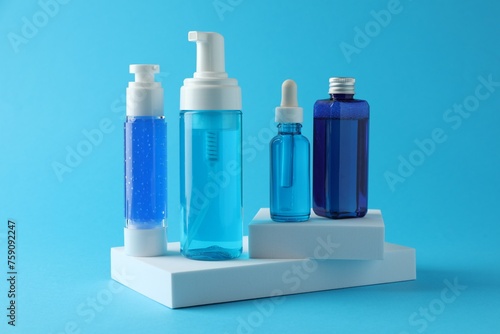 Set of luxury cosmetic products on light blue background