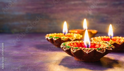 happy diwali clay diya lamps lit during dipavali hindu festival of lights celebration colorful traditional oil lamp diya on purple background