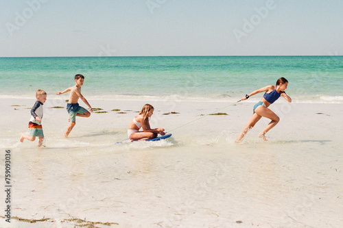 Carefree kids playing on the beach photo