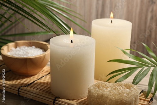 Composition with spa supplies and palm leaves on wooden table
