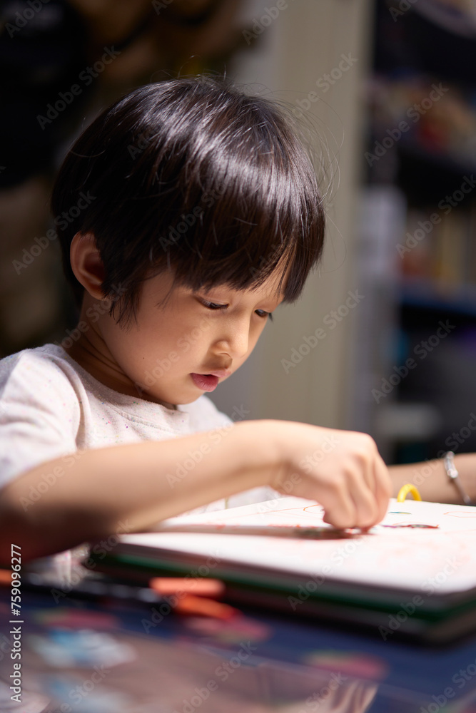 Asian little boy doing hand painting at home Asian little boy doing hand painting at home