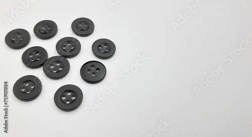 Black sewing buttons isolated on white background. Copy space for text.