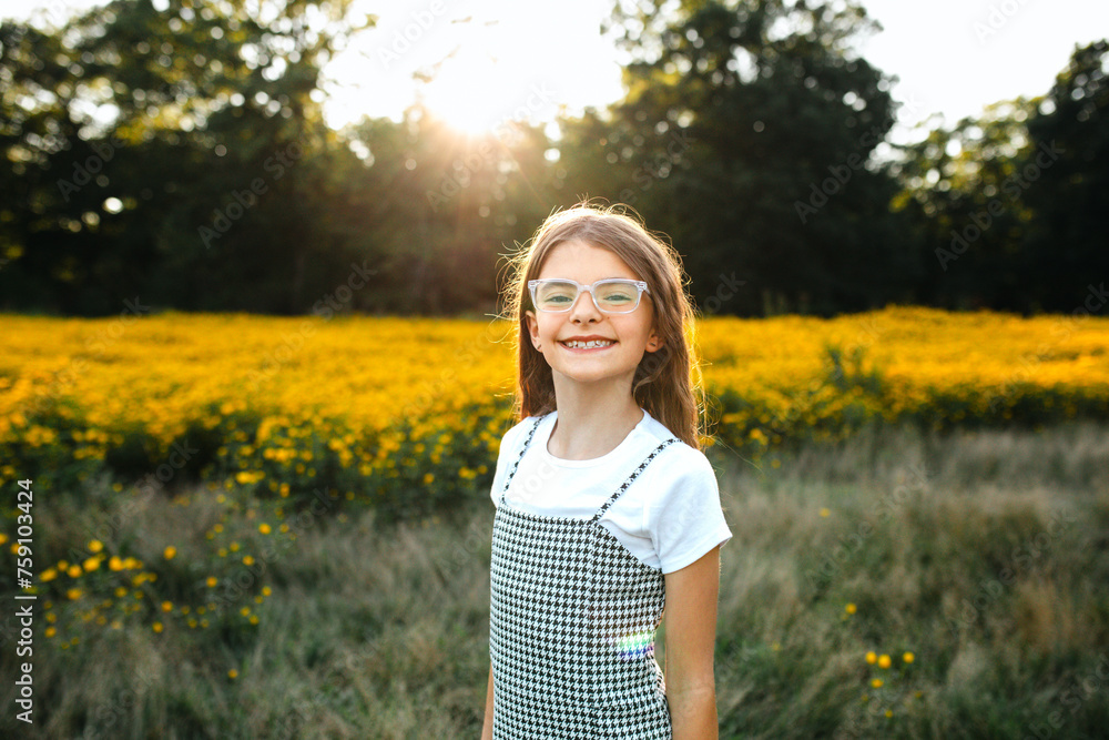 © Maria Manco/Stocksy - Preteen smiles at camera in wildflower field © Maria Manco/Stocksy - Preteen smiles at camera in wildflower field