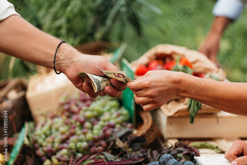 Man Paying for Groceries at Market photo