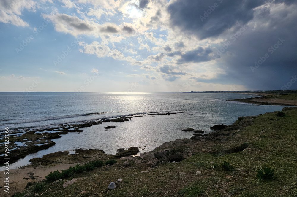 Sunset over a shore of the Mediterranean Sea in a rainy day Sunset over a shore of the Mediterranean Sea in a rainy day