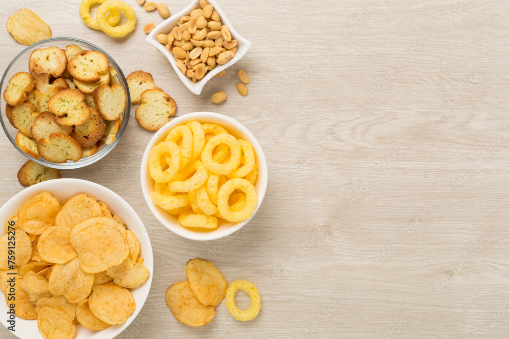 Different tasty snacks with sauce on wooden background, top view Different tasty snacks with sauce on wooden background, top view
