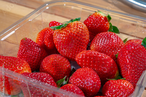 New harvest, plate with bio ripe red sweet strawberry from Spain
