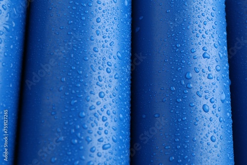 Energy drinks in wet cans as background, closeup