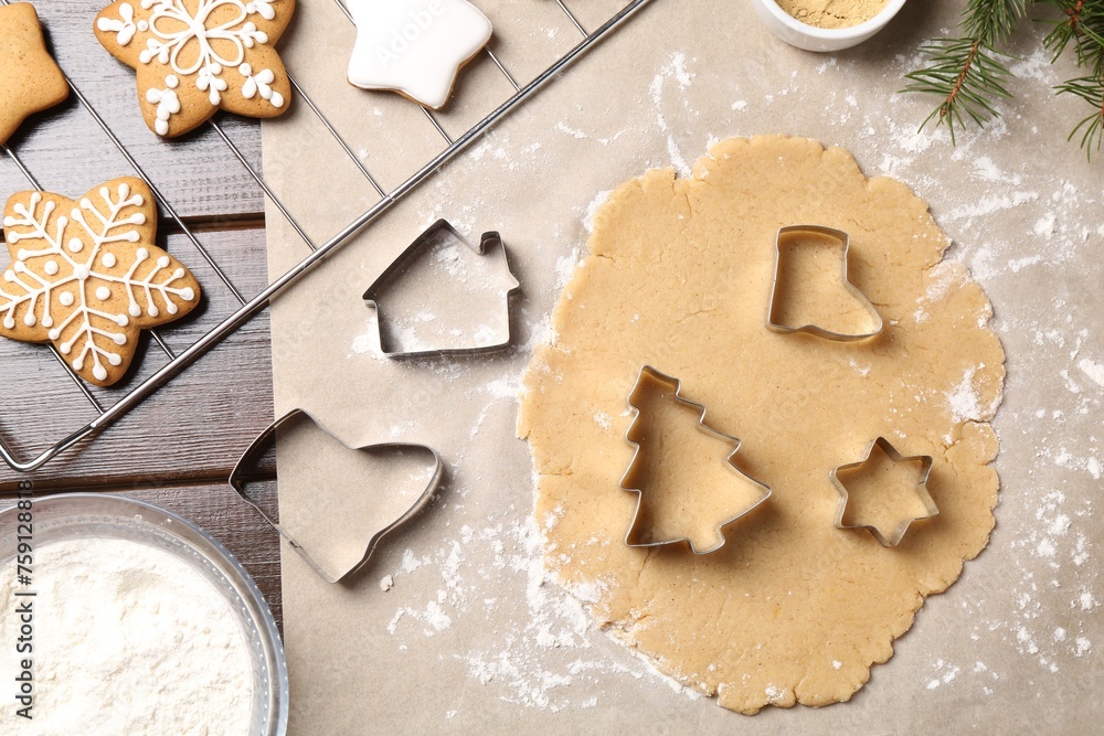 Making Christmas cookies. Flat lay composition with cutters and raw dough on wooden table Making Christmas cookies. Flat lay composition with cutters and raw dough on wooden table