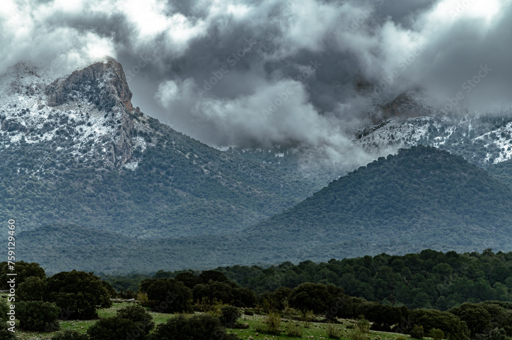 Panoramic view of snow-capped Sierra Arana (2027 meters altitude), southern Andalusia, on a stormy February morning