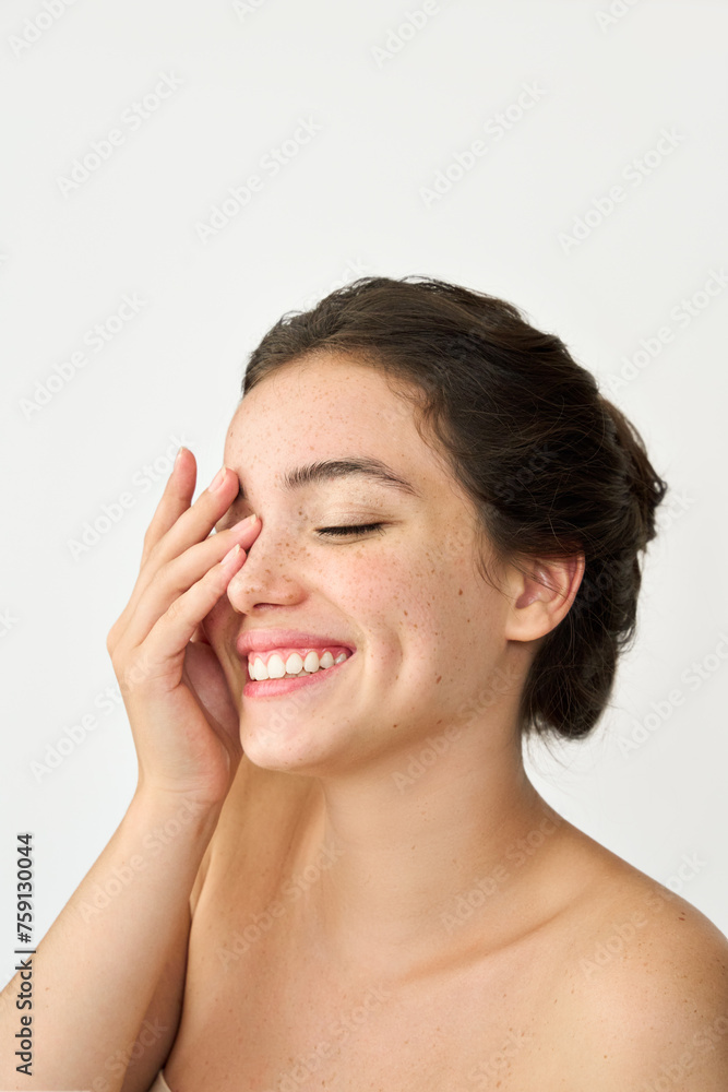 Aesthetic beauty photo of smiling young woman with freckles on face enjoying fresh clean healthy skin care. Happy brunette Latin girl isolated on white background advertising skincare cosmetics. Aesthetic beauty photo of smiling young woman with freckles on face enjoying fresh clean healthy skin care. Happy brunette Latin girl isolated on white background advertising skincare cosmetics.