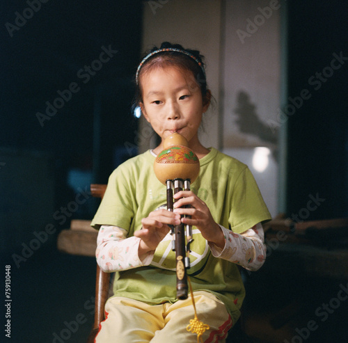 The girl is playing traditional Chinese instruments
 photo