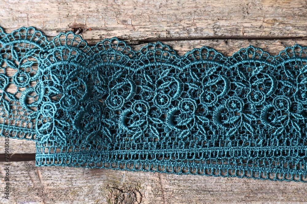 Beautiful lace on wooden table, top view