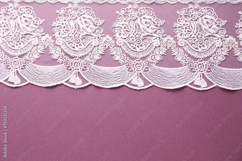 White lace on purple background, top view. Space for text
