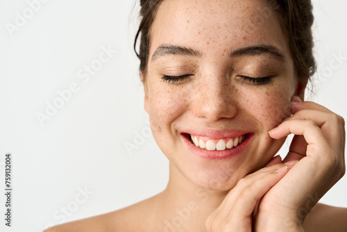 Fotografie Close up beauty photo of smiling young adult woman with freckles on face enjoying fresh clean healthy skin advertising skincare beauty cosmetics