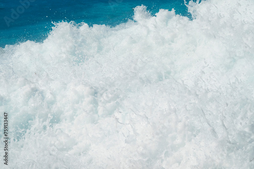 Amazing turquoise sea water and wave splash foam photo