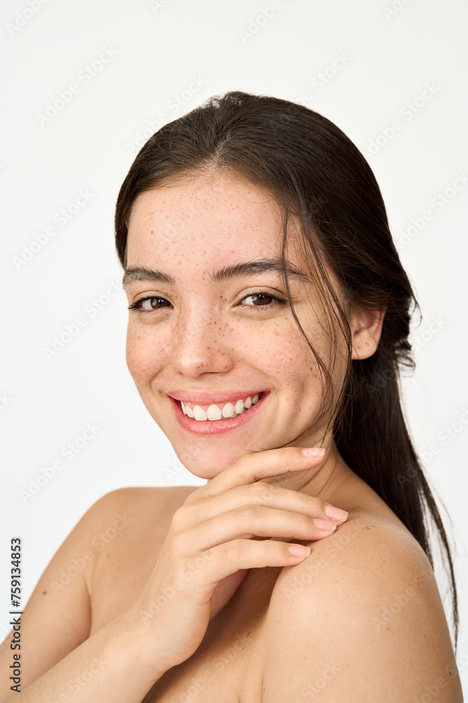 Vertical portrait of happy Hispanic young woman with freckles on face isolated on white background. Beauty aesthetic shot of smiling pretty Latin girl model looking at camera advertising skin care. - obrazy, fototapety, plakaty 