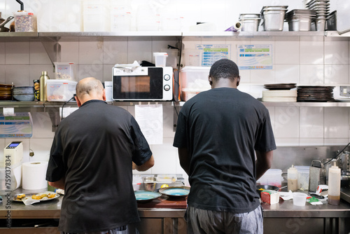 Diverse chefs working in restaurant kitchen photo