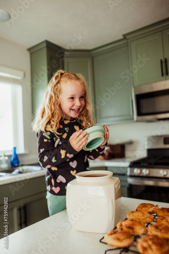 Child take cookie jar lid off. photo