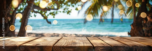 Empty wooden planks table against a blurred background with a sea coast with palm trees and glowing light bulbs in the evening, banner