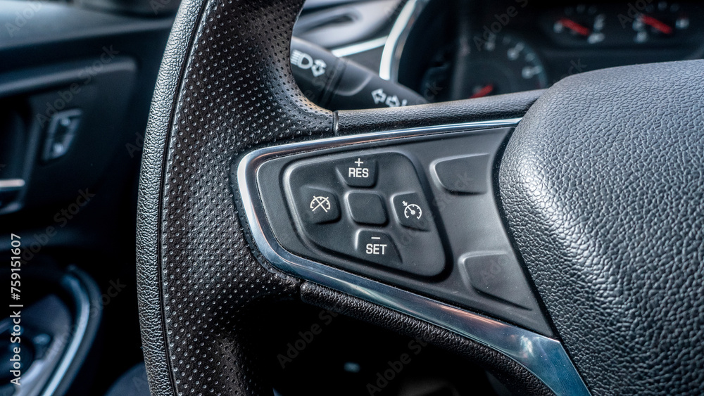 cruise control buttons on the steering wheel in a new car