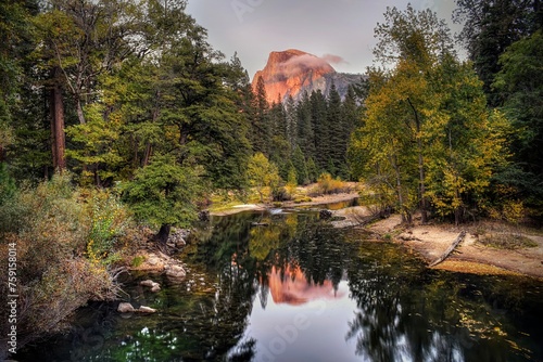 Half dome reflected in river at sunset photo