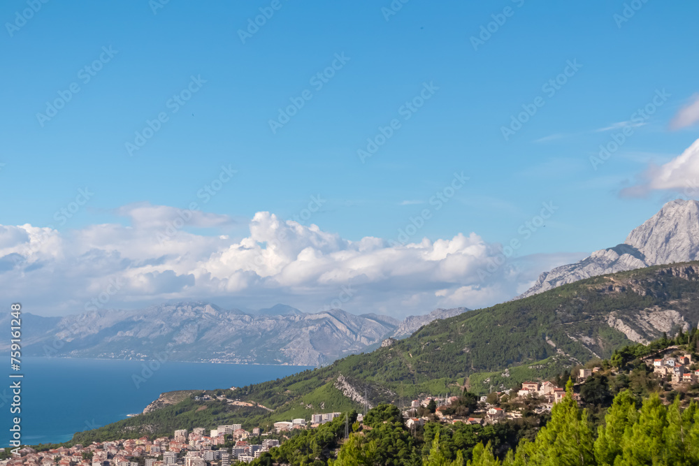 Idyllic hiking trail along coastline of Makarska Riviera in coastal village Kotisina, Split-Dalmatia, Croatia, Europe. Panoramic vista of mountain ridges in Biokovo nature park, Dinaric Alps, Balkan