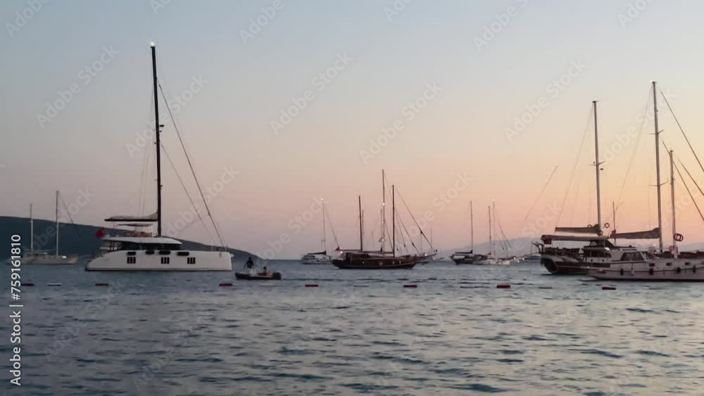 Dusk over a tranquil marina with moored sailing boats Dusk over a tranquil marina with moored sailing boats