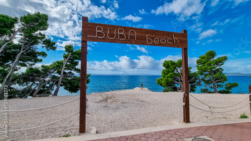 Bilde på lerret Wooden sign indicating the entrance to idyllic Buba beach along Makarska Riviera, Split-Dalmatia, Croatia, Europe