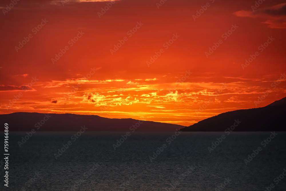 Idyllic sunset view of Dalmatian archipelago seen from coastal town Makarska, Split-Dalmatia, Croatia, Europe. Silhouette of islands. Coastline of Makarska Riviera, Adriatic Sea. Balkans in summer Idyllic sunset view of Dalmatian archipelago seen from coastal town Makarska, Split-Dalmatia, Croatia, Europe. Silhouette of islands. Coastline of Makarska Riviera, Adriatic Sea. Balkans in summer