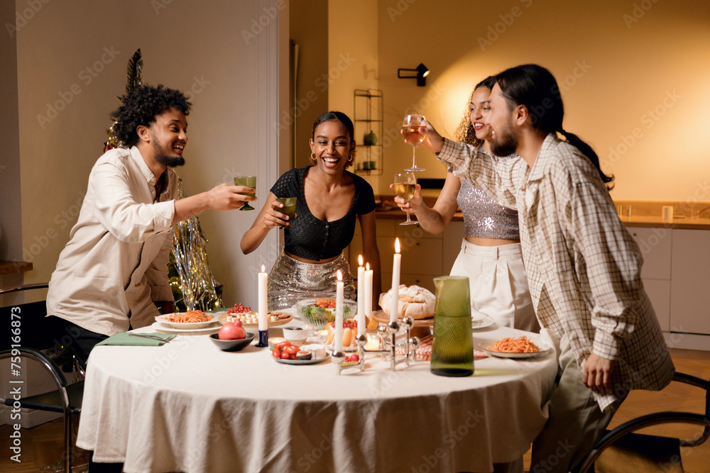 Cozy festive meeting: Friends over Christmas dinner Cozy festive meeting: Friends over Christmas dinner