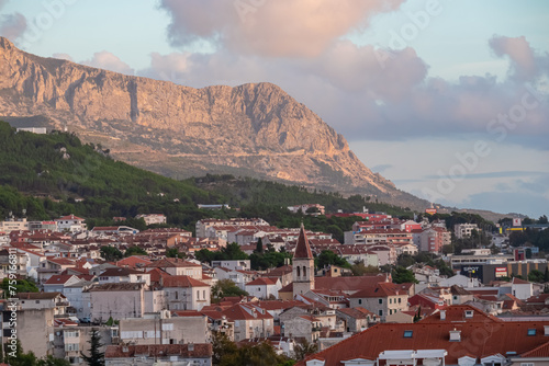 Aerial sunset view of coastal village Makarska, Split-Dalmatia, Croatia, Europe. Landmarks old town, Adriatic Mediterranean architecture. Travel destination in summer. Biokovo mountains, Dinaric Alps photo