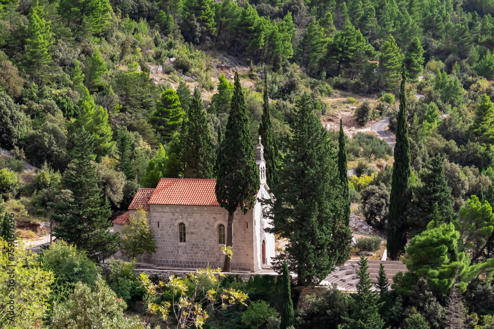 Scenic view of ancient catholic church of St. Anthony in village Kotisina near Makarska, Split-Dalmatia, Croatia, Europe. Hiking in Biokovo nature park in mountain of Dinaric Alps, Balkan. Forest