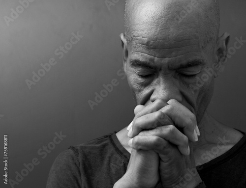 man praying to god with hands together worshiping God Caribbean man praying with people stock image stock photo 