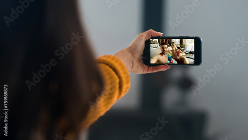Happy friends videocalling cellphone online. Closeup hands holding smartphone