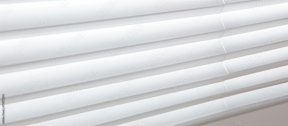 Obraz premium A close up of a grey metal blind with a wood pattern on a rectangular window. The blind has tinted shades and wire pipes for adjustment