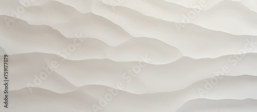 A closeup of a cloud grey paper with cumulus waves, resembling a freezing landscape painting with petal patterns on a foggy slope