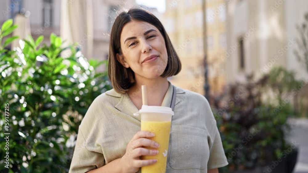 Young beautiful hispanic woman drinking bubble tea in the streets of Vienna Young beautiful hispanic woman drinking bubble tea in the streets of Vienna